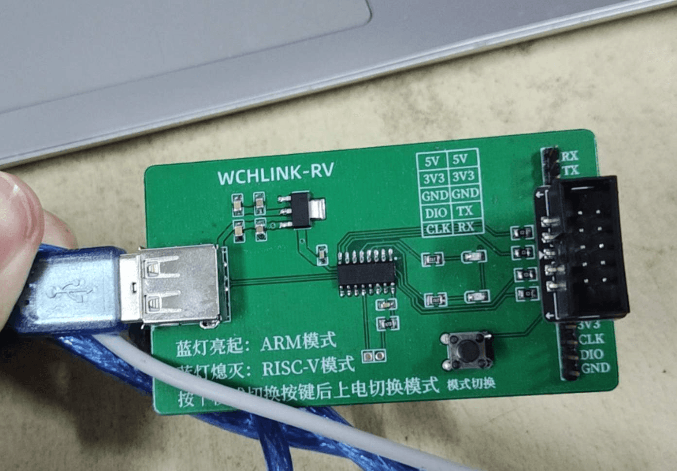 A green DIY WCHLINK-RV board, CH549 in SOP-16, with a 10-pin box header and Chinese silkscreen describing the mode button