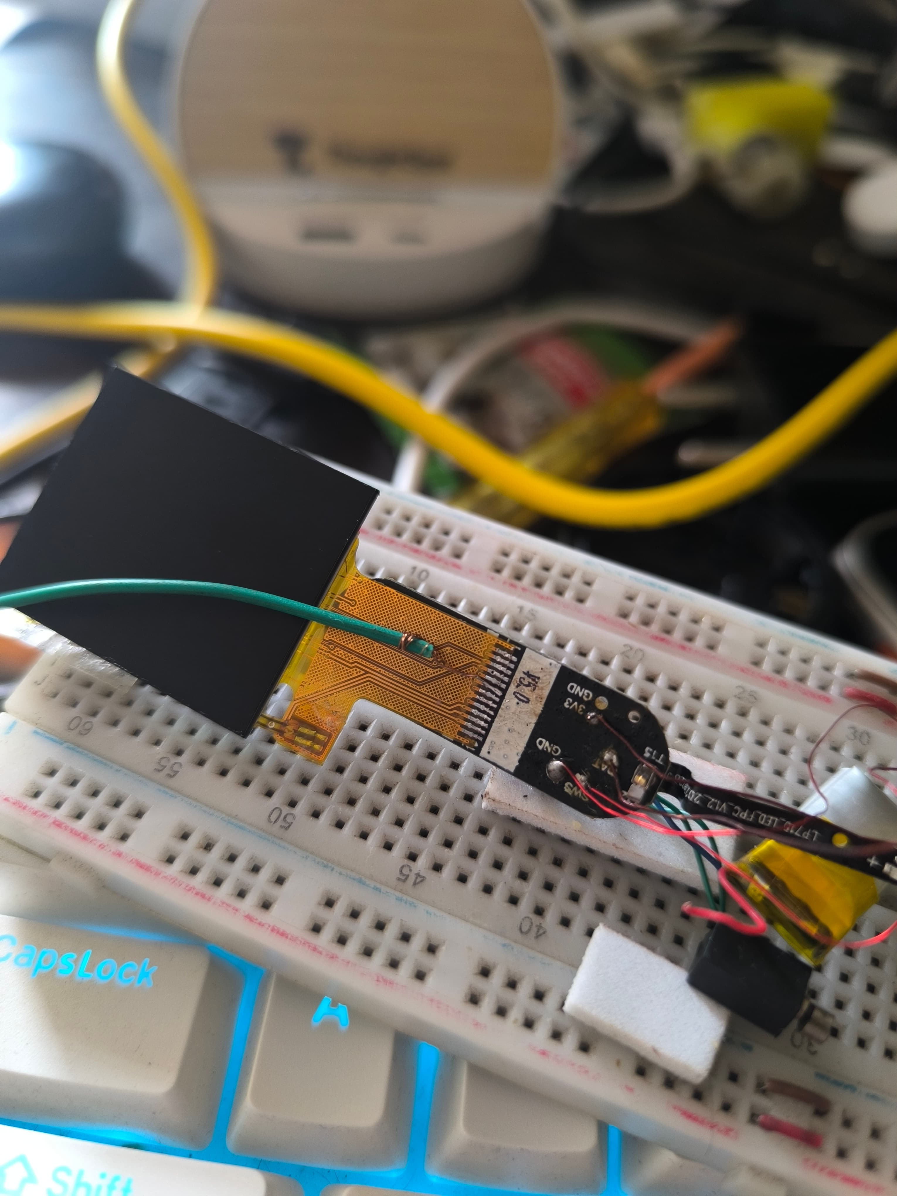 A single green wire soldered to one pin of the display FPC