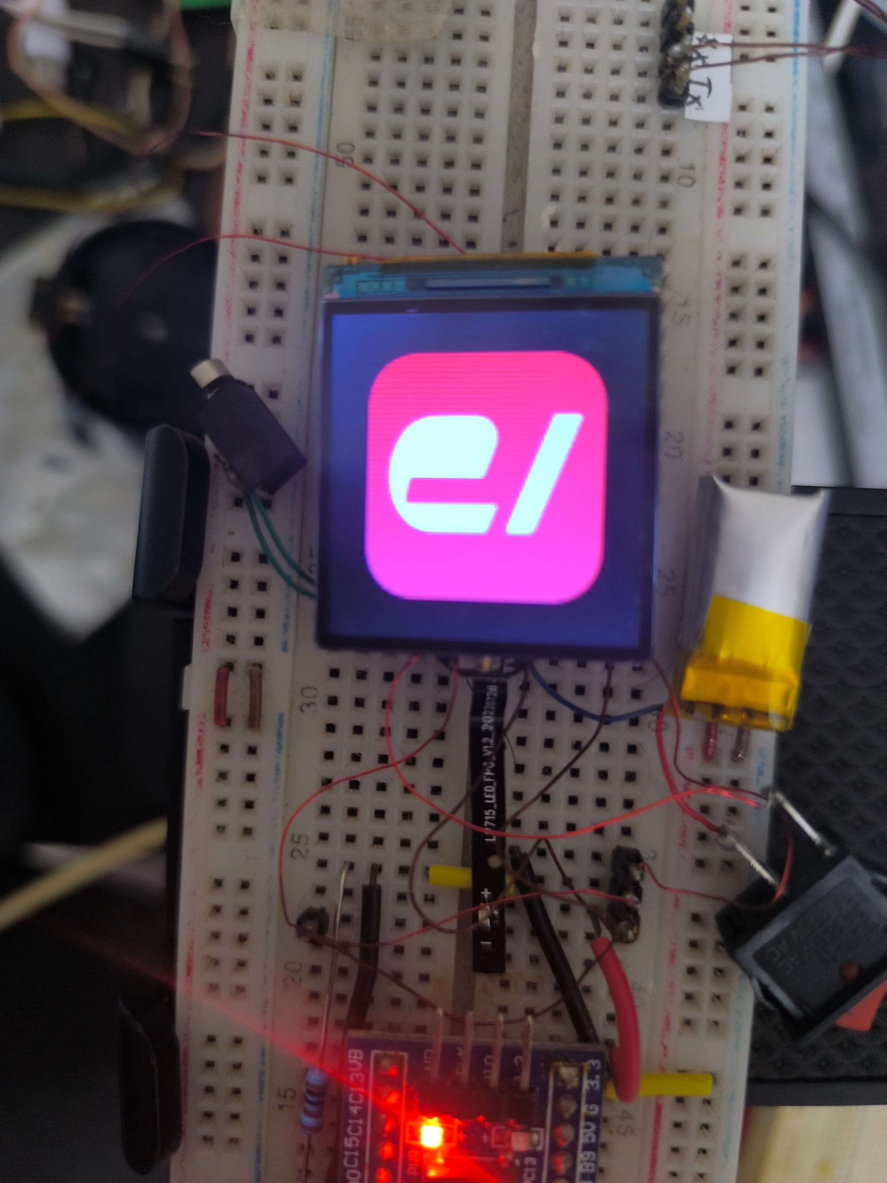The square e-lab mark on the watch display