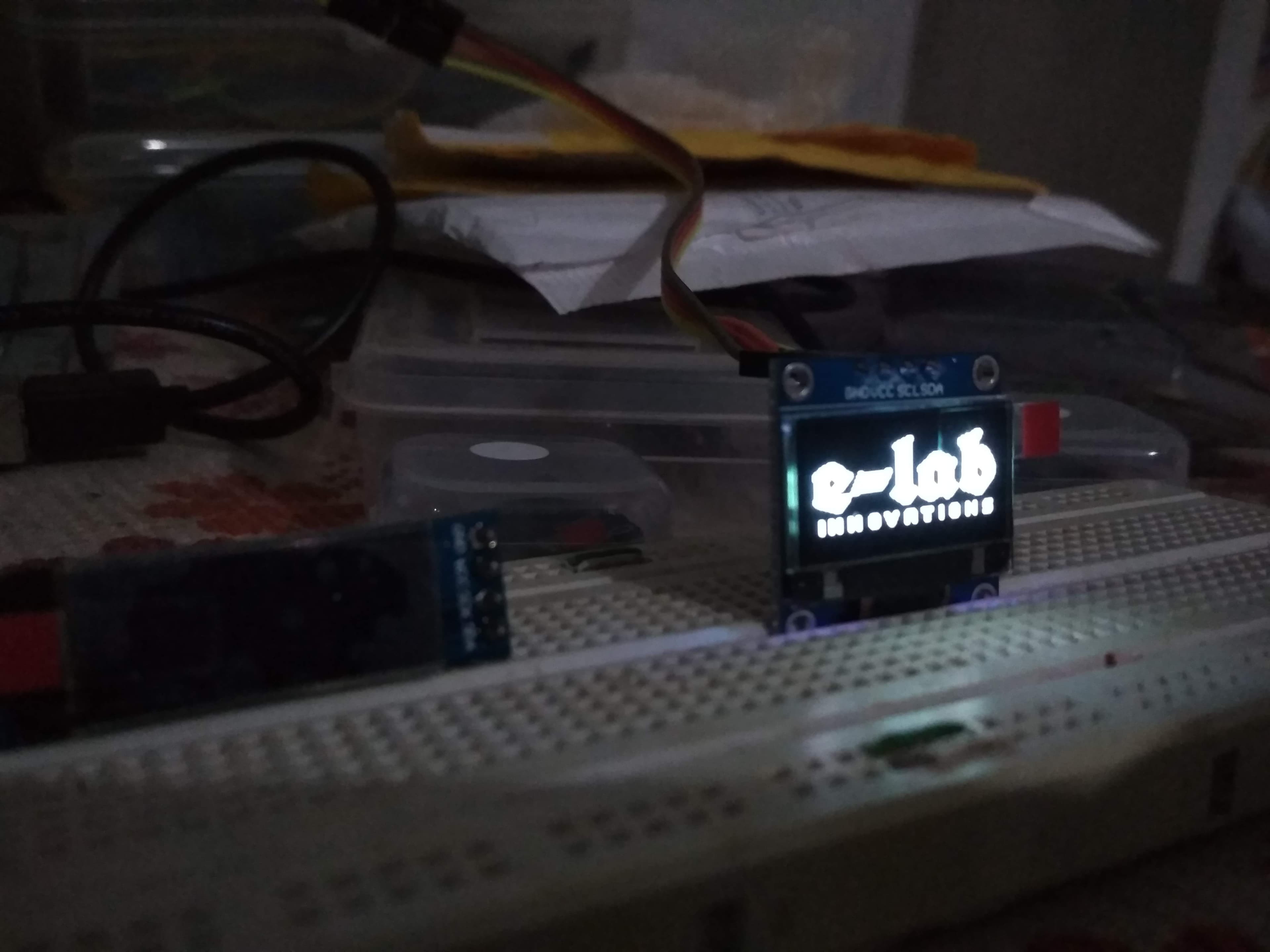 The 2019 e-lab innovations logo displayed on a 0.96-inch OLED using the U8G2 library.